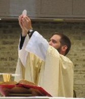 A person in a white robe
        holding up a candleAI-generated content may be incorrect.