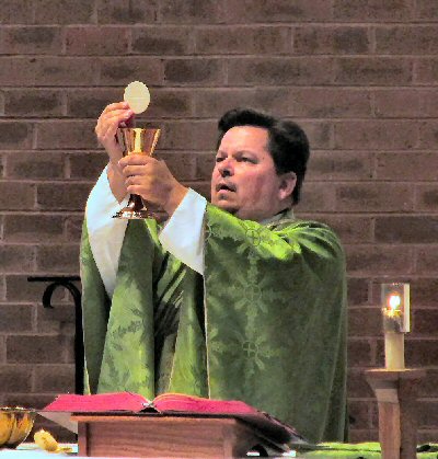 A person in green robe holding a chaliceAI-generated
        content may be incorrect.