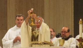 A priest raising a
        chaliceAI-generated content may be incorrect.